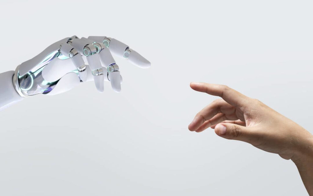 Une main humaine tendue vers une main de robot futuriste, sur fond clair, symbolisant la connexion entre l'homme et la technologie.